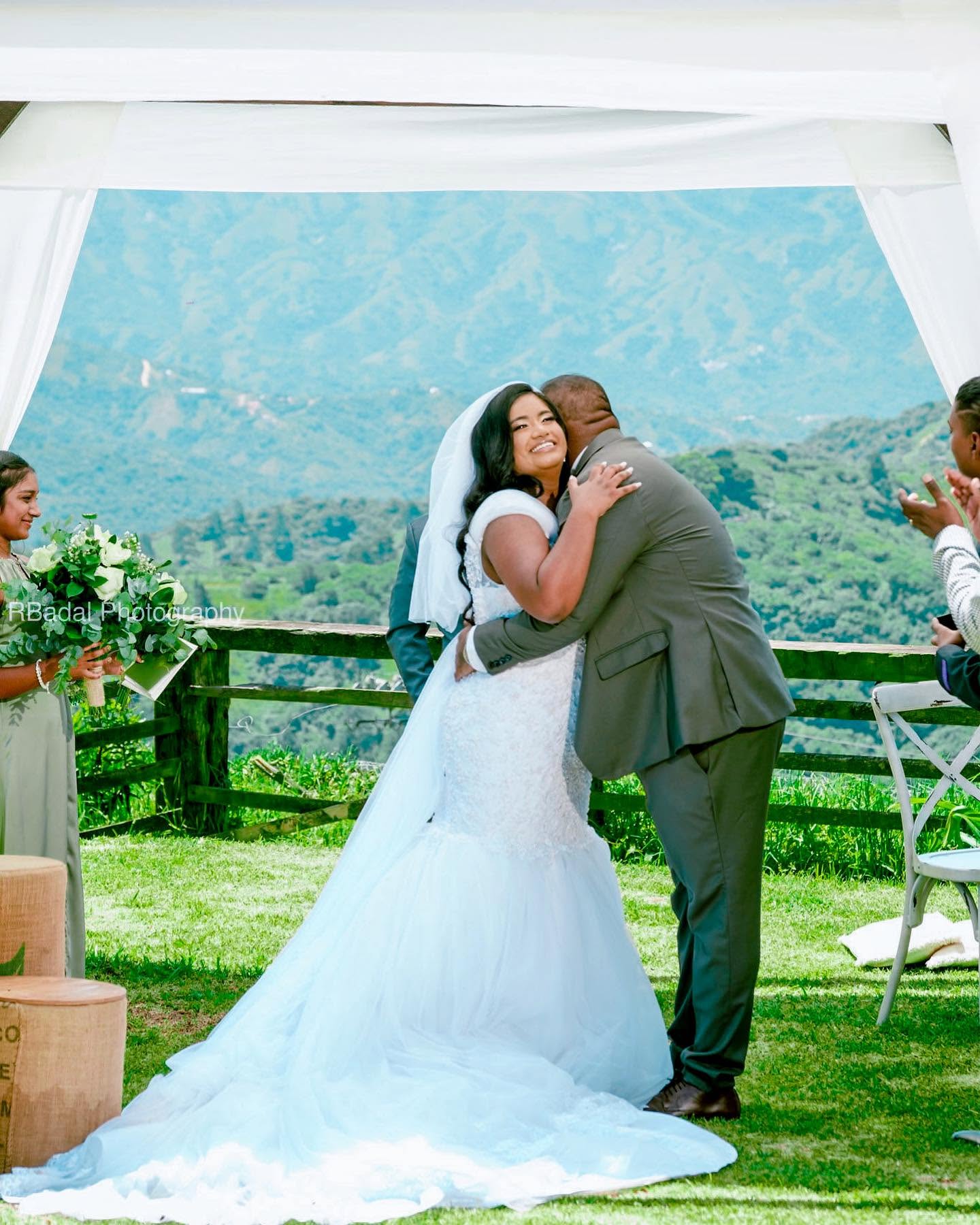 A couple embracing under the gazebo above the valley