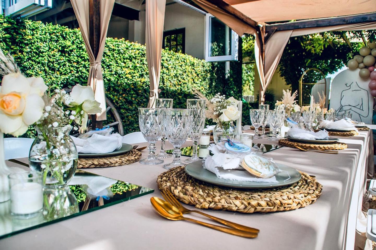 Garden lunch table with crystal glassware and woven placemats