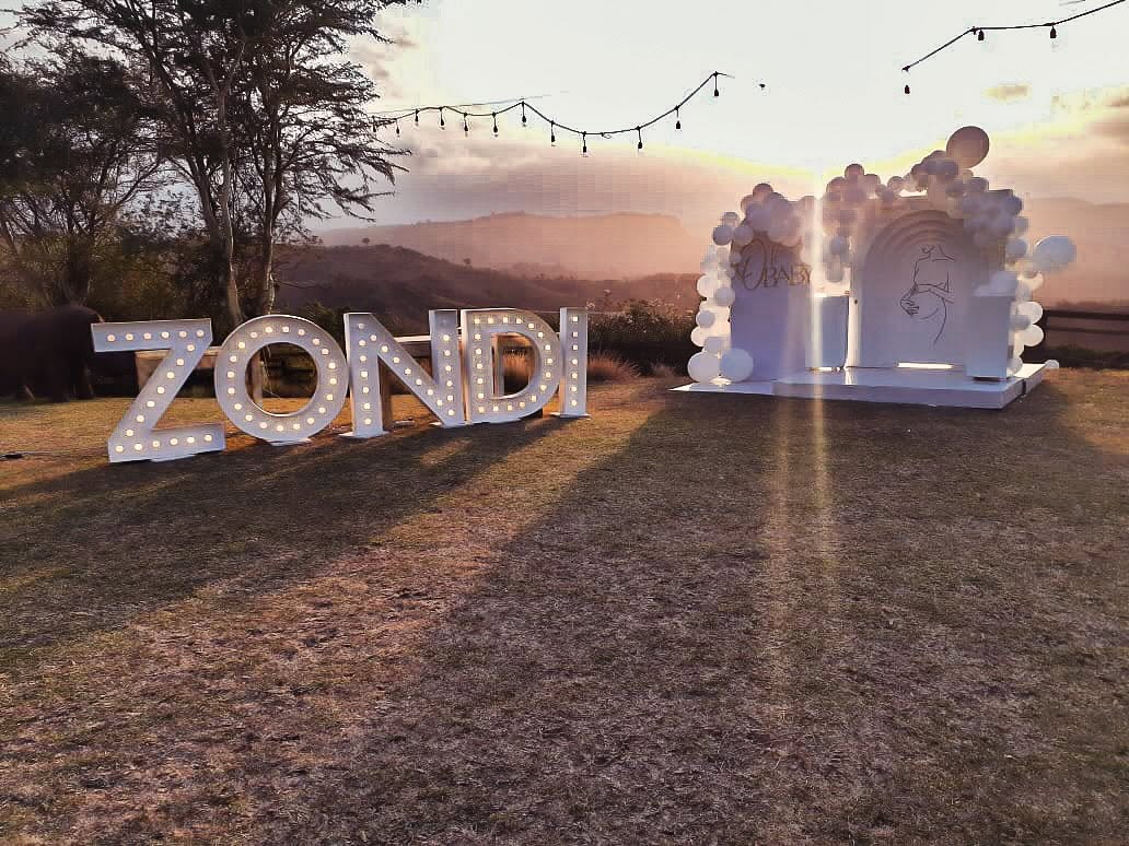 Illuminated marquee letters on the lawn at sunset